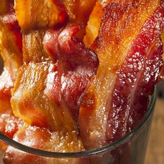 oven cooked bacon is easy to make. Cook oven fried bacon in the oven for an easier way to make bacon. This is a simple no hassle cooking method that we've used repeatedly to make bacon in the oven.