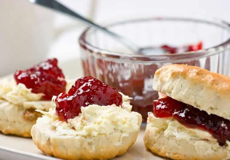 3 buttermilk biscuits with strawberry jam on top