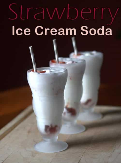 three Strawberry Ice Cream Soda glasses lined up next to each other with a grey and white straw