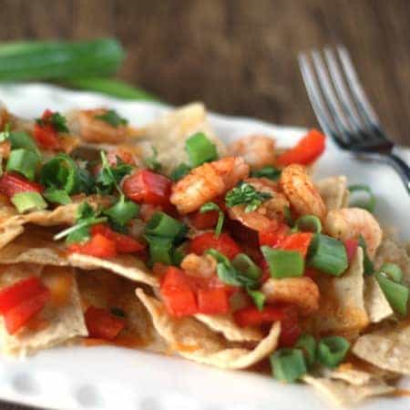 Want to lighten up your nachos? Try our slightly cheesy appetizer recipe with shrimp. Quick and easy dinner recipe.