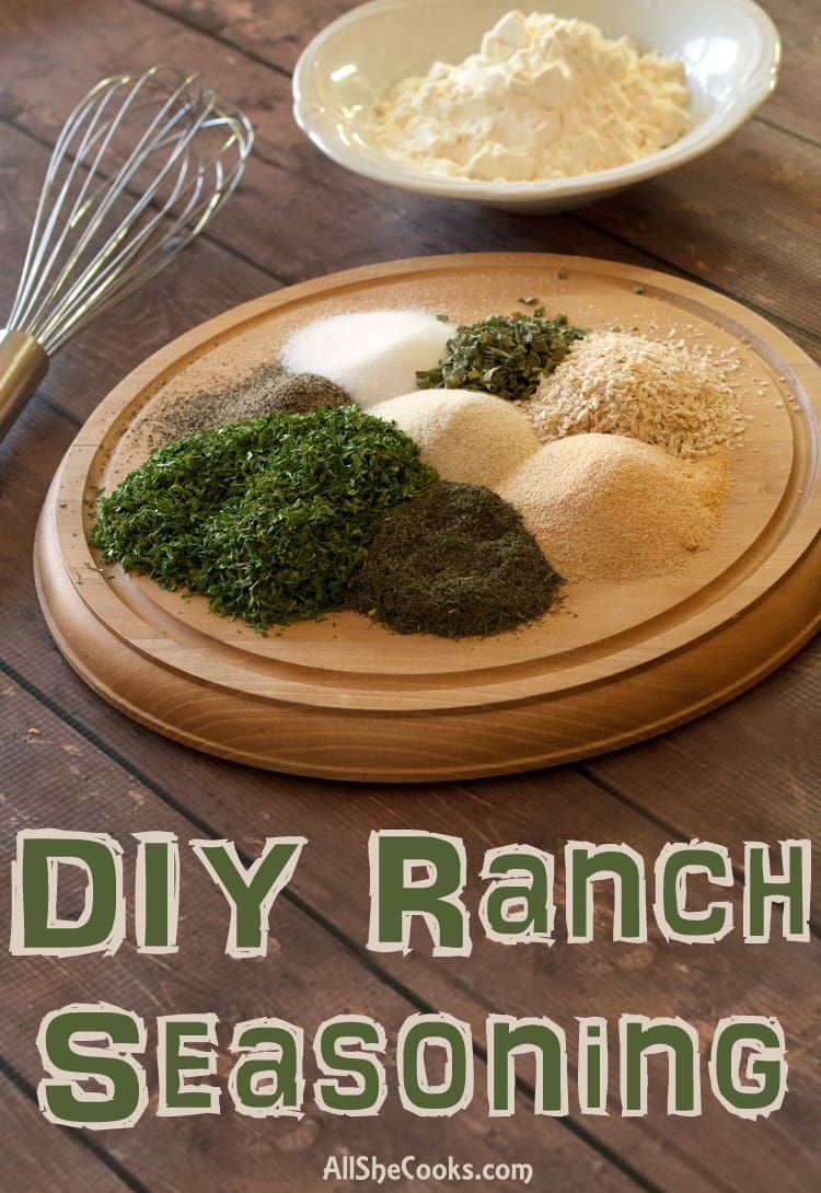 ranch dressing mix on a wooden platter next to a wire whisk and bowl of buttermilk