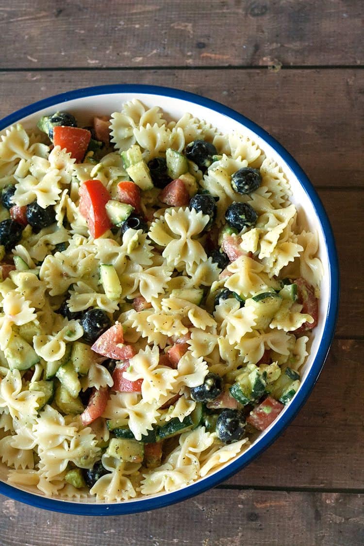 overhead view of avocado pasta salad on wood showcasing avocado salad recipes