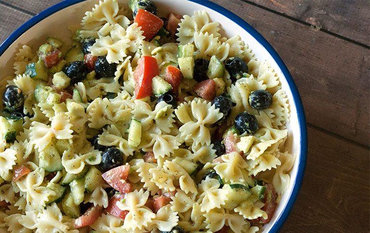 overhead view of avocado salad recipes including avocado pasta salad