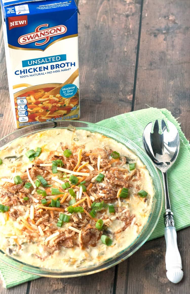 Easy green bean casserole made with frozen green beans in a glass pie dish with a serving spoon