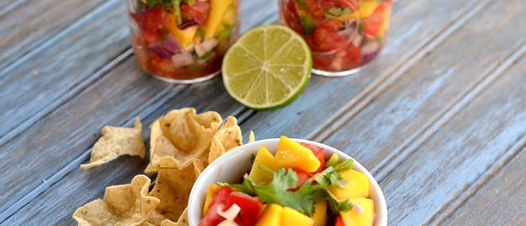 Mango Salsa in jars with bowl in front