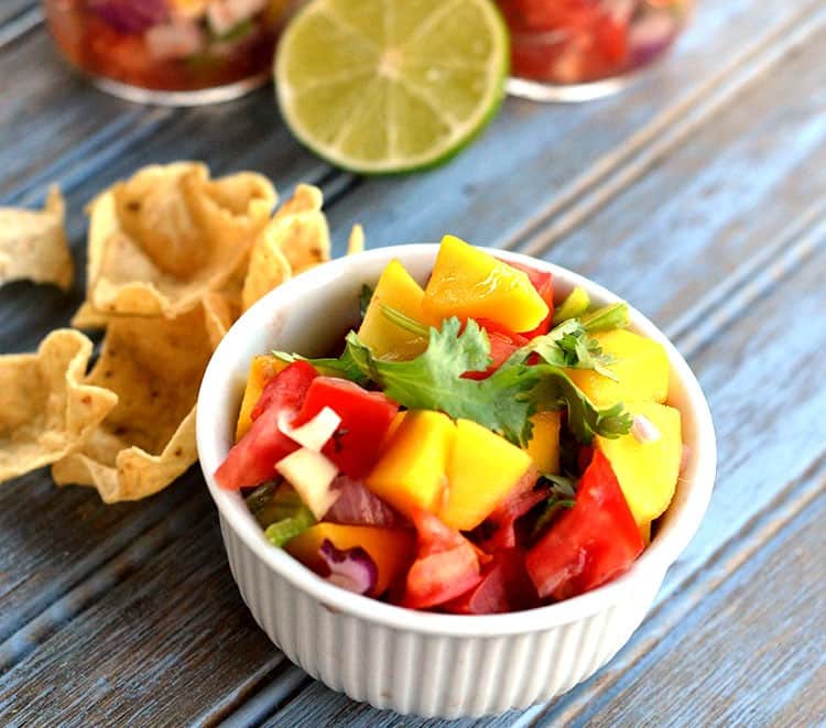 Mango Salsa in a bowl with chips by it