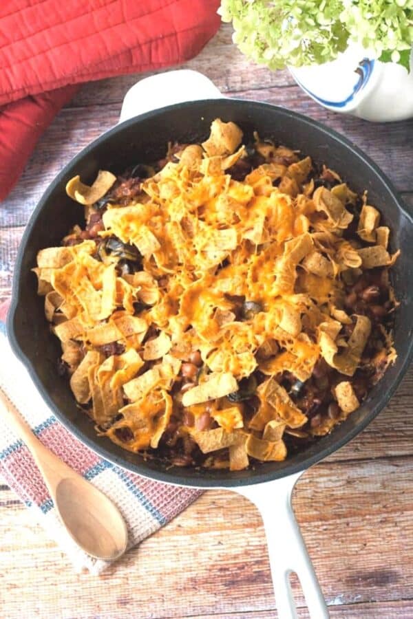 chili corn chip casserole being served in a skillet