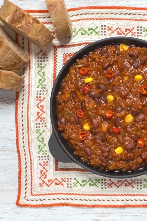 texas chili being served with crusty bread