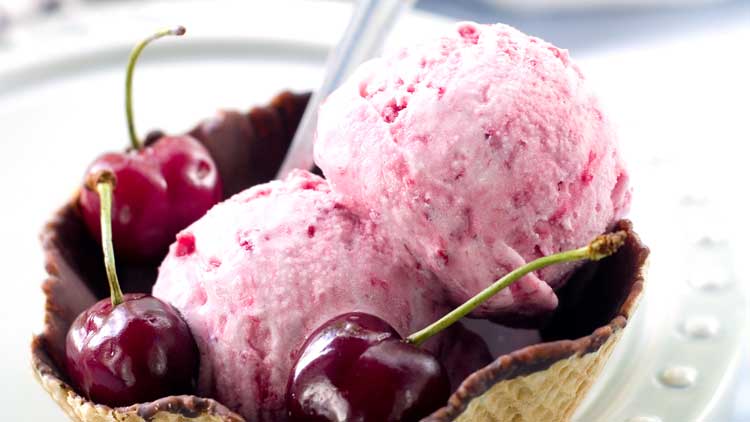 cherry ice cream in chocolate ice cream bowl on white plate