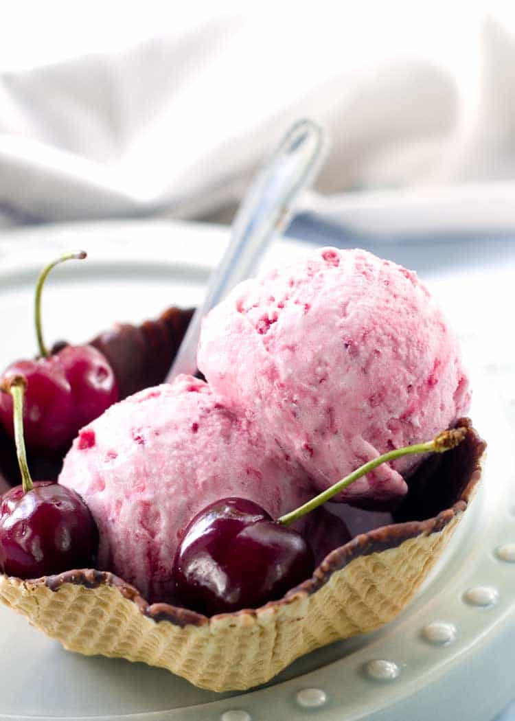 cherry ice cream in chocolate ice cream bowl on white plate