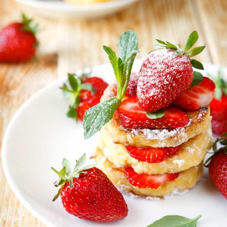 pancakes with strawberries on white plate