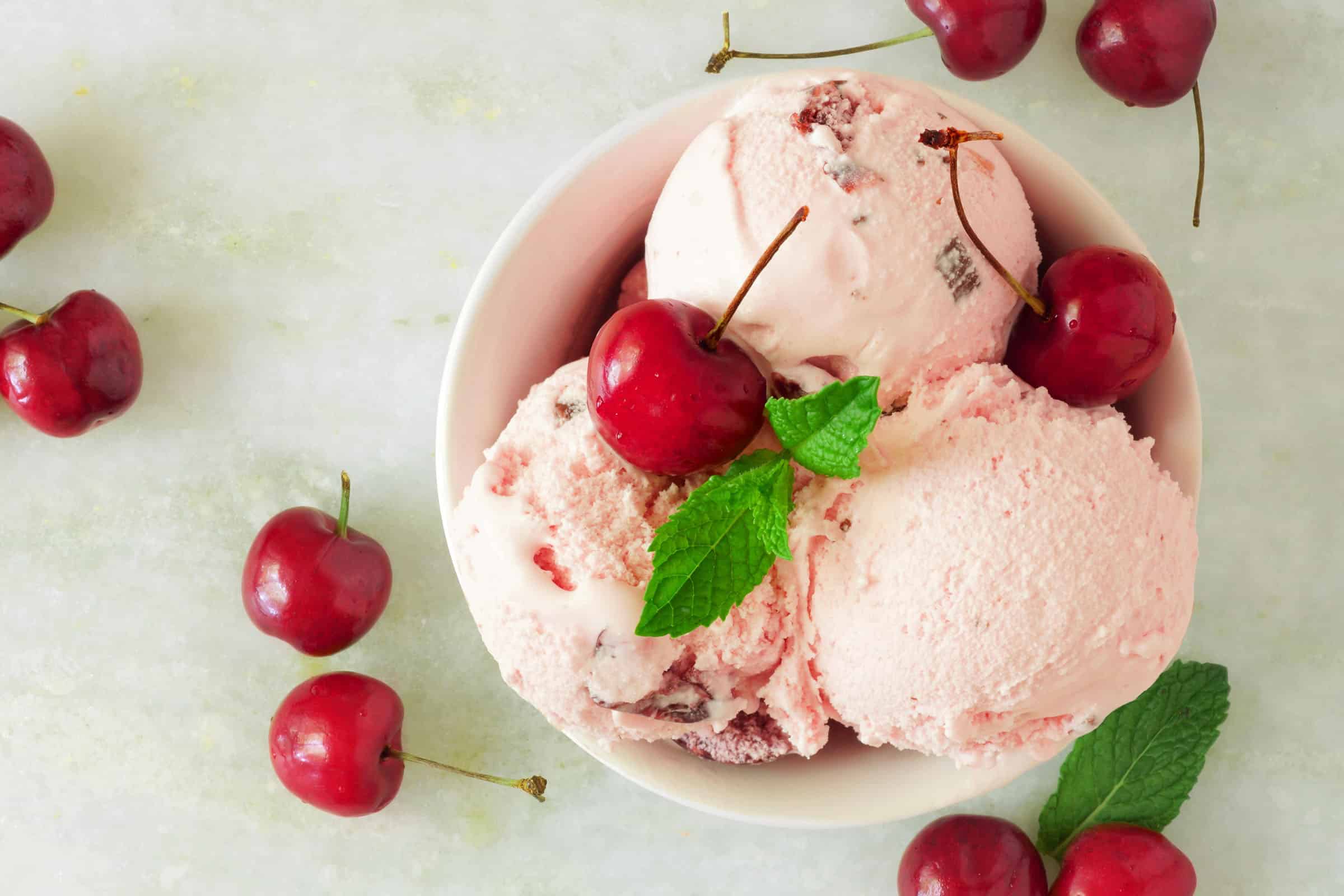 homemade copycat cherry garcia ice cream in a white bowl
