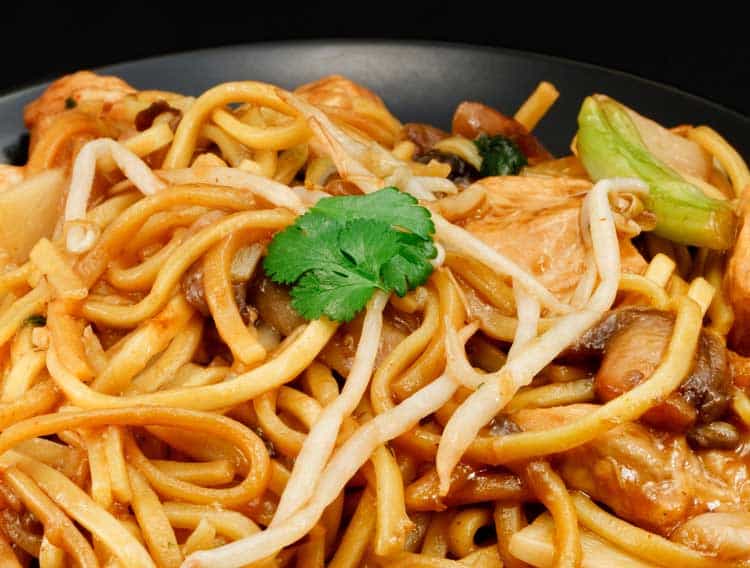 chow mien noodles on black plate