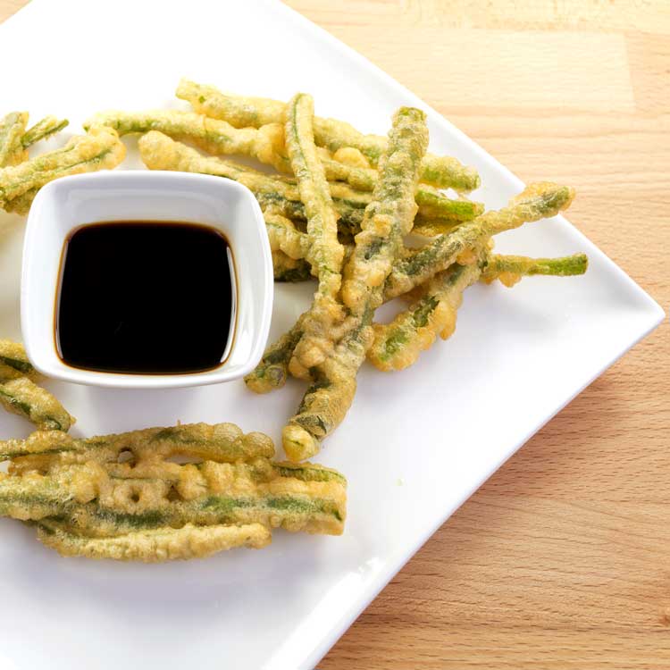 fried green beans with sauce on white plate
