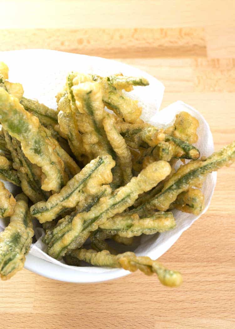 fried green beans with sauce on white plate