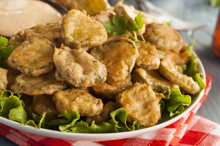 friend pickles on a bed of lettuce on white plate