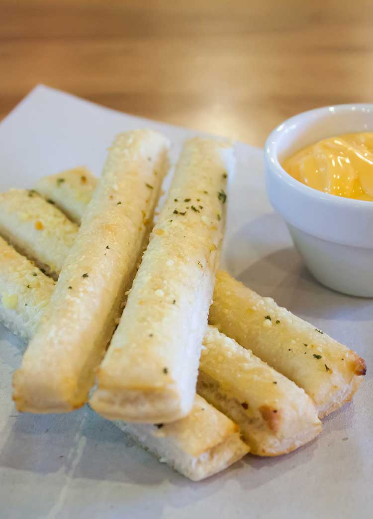 breadsticks on white parchment paper