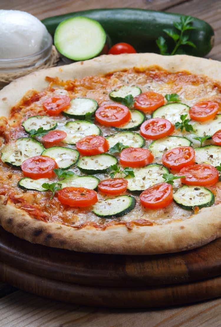 vegetarian pizza with zucchini on wood table