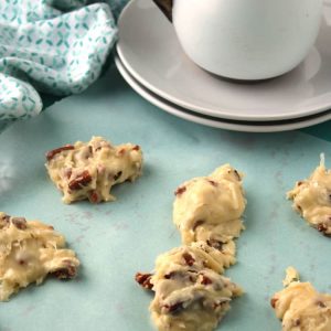 blue towel with coconut clusters on top and a saucer and cup in the background