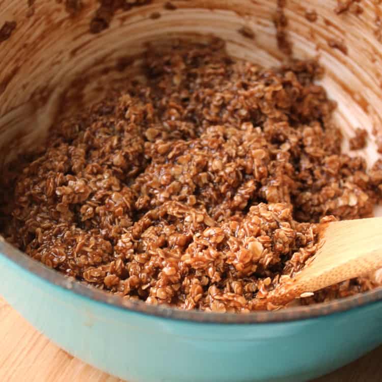 closeup of no bake chocolate oatmeal cookies batter in a blue bowl