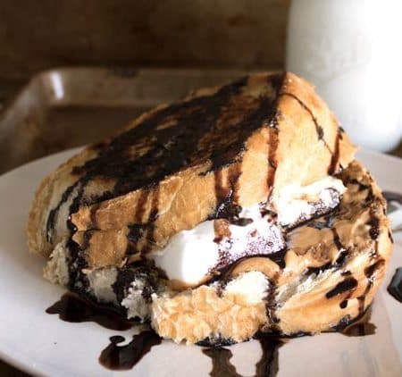 This Cinnamon Toast sandwich is filled with peanut butter, chocolate sauce, and marshmallows. It's and Ooey Gooey Sandwich that is a perfect special treat recipe for those days you just want to be a bit indulgent. Kids love this recipe.