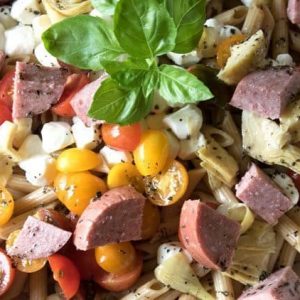 Fresh, flavorful salad that can be enjoyed any time of the year. This Caprese Pasta Salad recipe with Artisinal Sauasage is the best pasta salad recipe to bring to a potluck.
