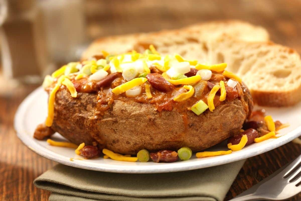 chili baked potato on a white plate