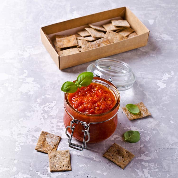 canned crushed tomatoes being served in a glass jar
