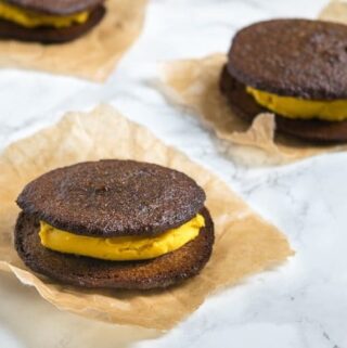 Pumpkin Cream Filled Whoopie Pies - a healthy pumpkin cookie filled with velvety pumpkin cream for a delicious fall treat!