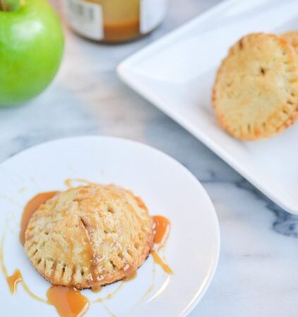 Caramel Apple Hand Pies- This delectable, delicious dessert that's a perfect personal pie for the entire family. These pies are baked in a flaky, buttery pie dough and filled with a cinnamon apple caramel filling.