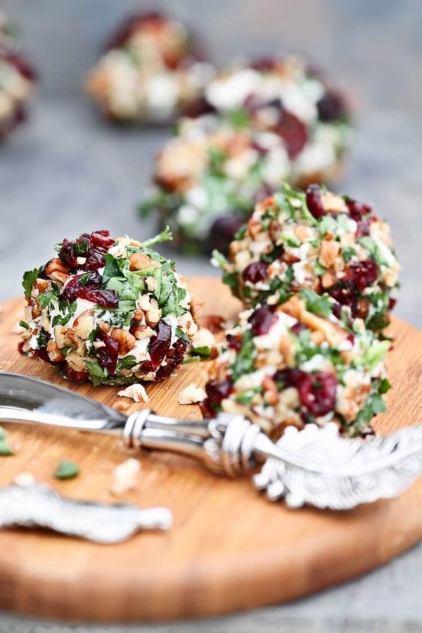 cranberry pecan goat cheese balls on a cutting board