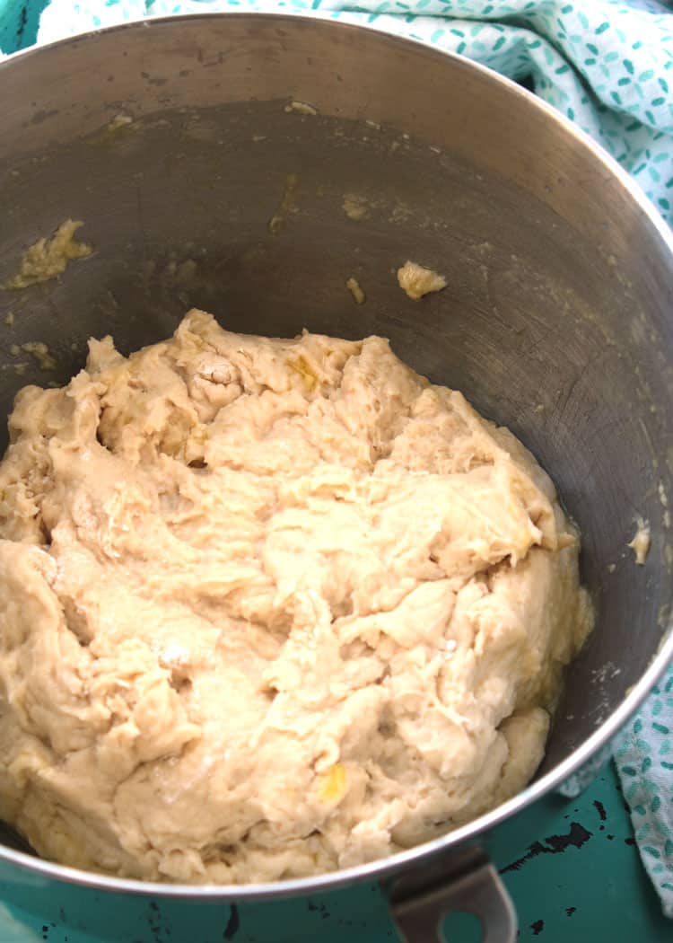 dough for easy yeast rolls inside of a stainless steel bowl