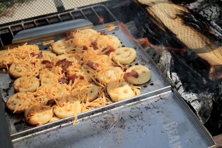 Loaded french fries on the campfire.