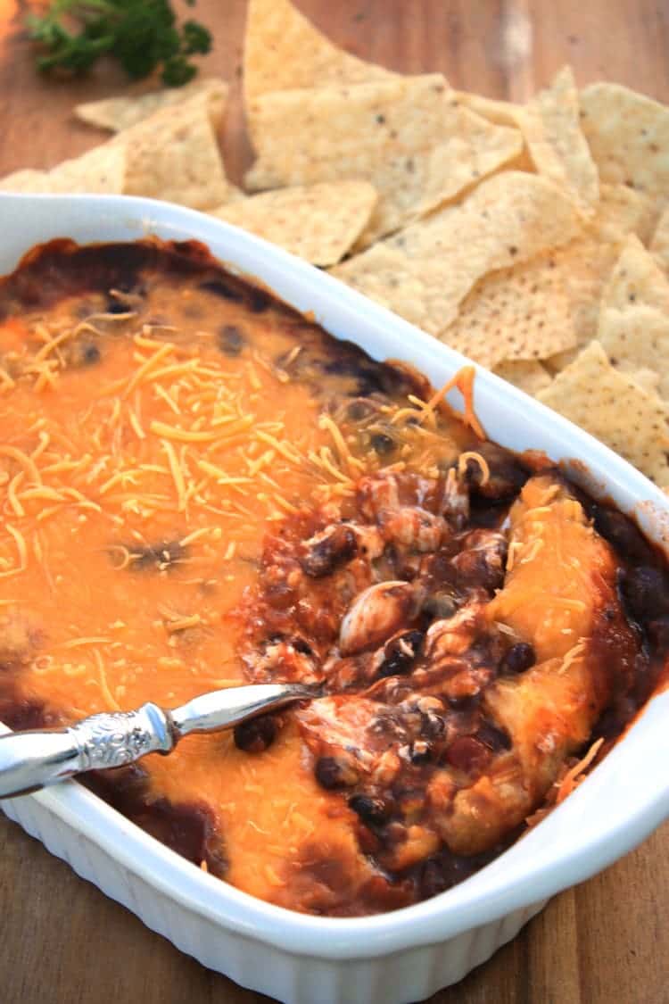 chili cheese dip being served with a spoon