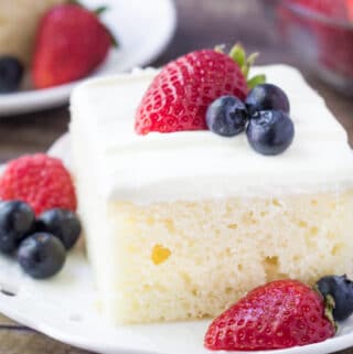 This berries and cream sheet cake is perfect for summer. It's a delicious vanilla sheet cake with a soft cake crumb. Then it's topped with a cream cheese topping & fresh berries.