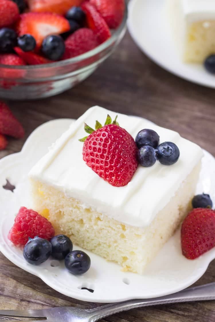 This berries and cream sheet cake is perfect for summer. It's a delicious vanilla sheet cake with a soft cake crumb. Then it's topped with a cream cheese topping & fresh berries.