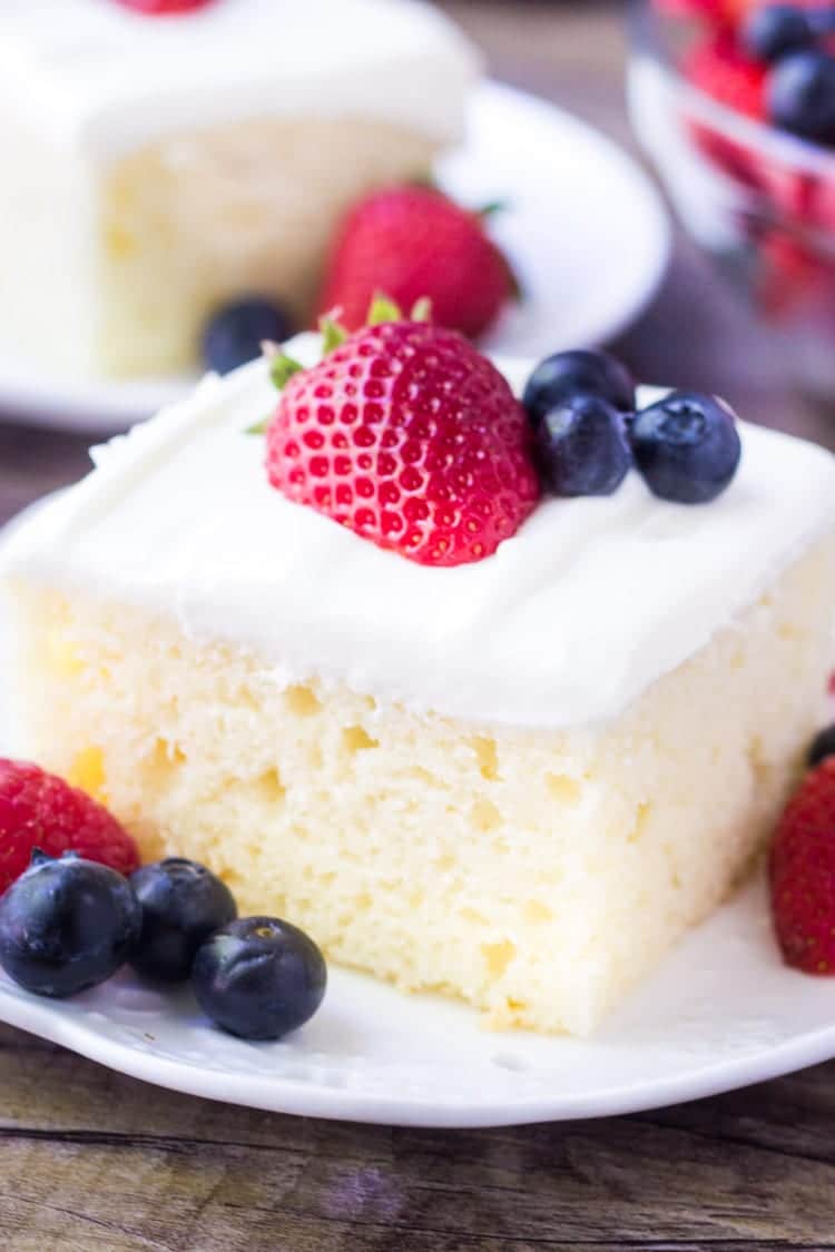 Easy sheet cake recipe topped with berries great when trying to figure out what to bring to a potluck.