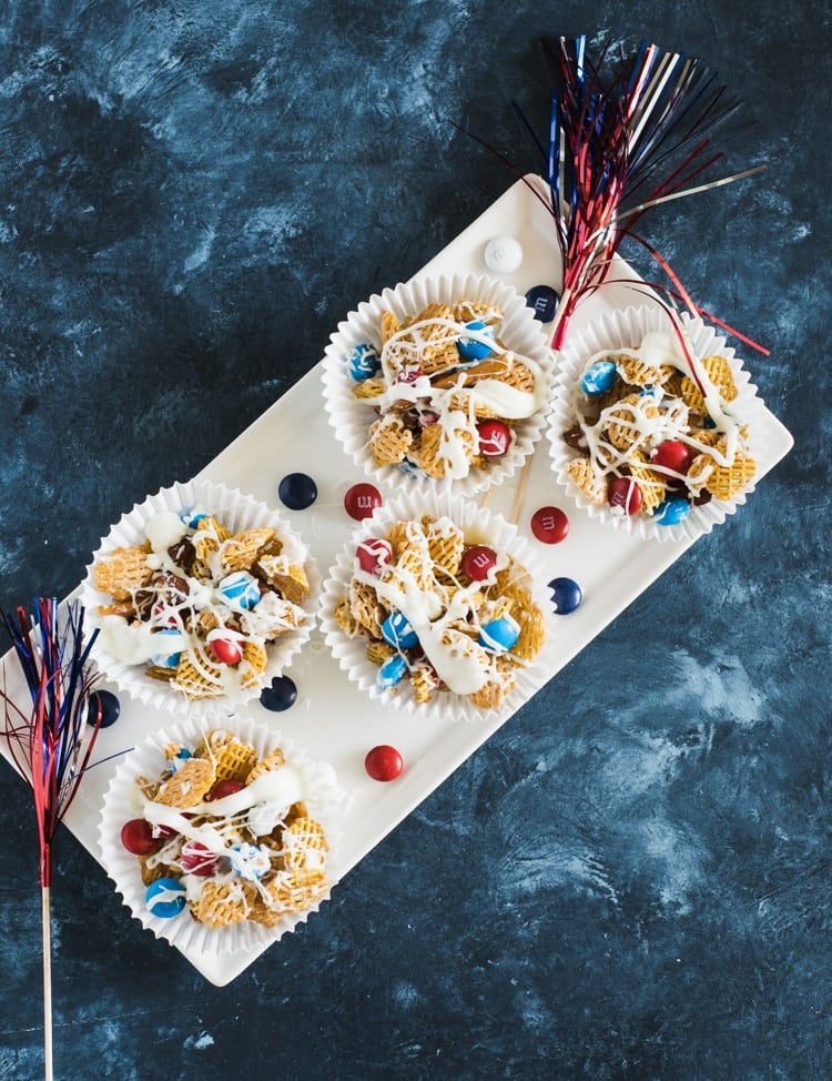 Individual servings of white chocolate drizzled patriotic Crispix snack mix 