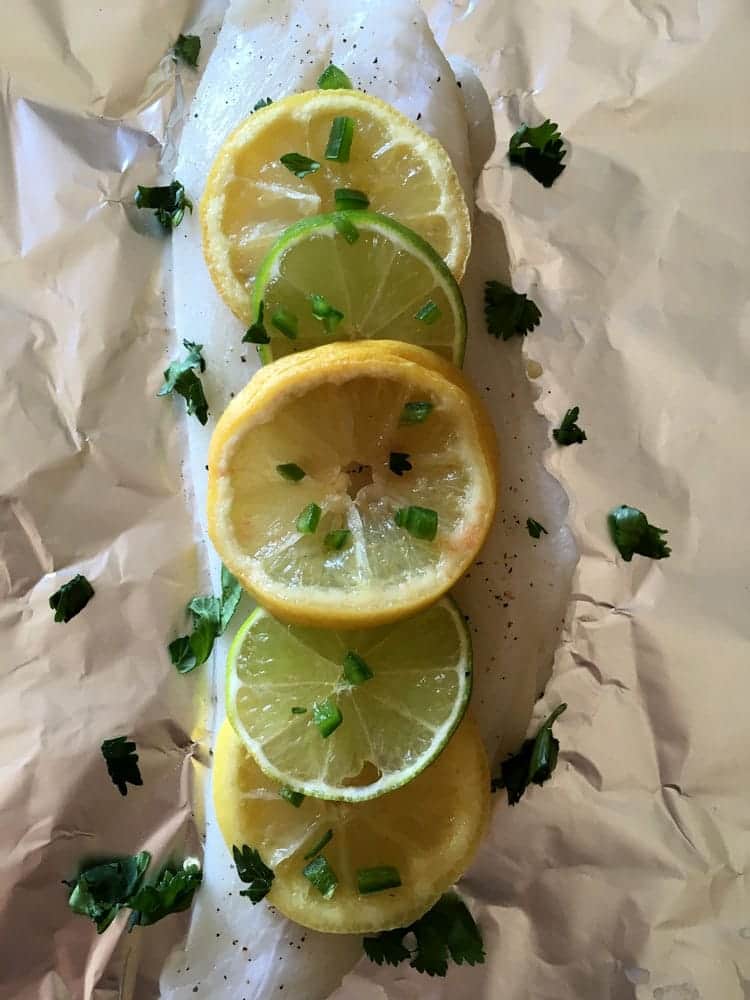 sliced lemons and limes on aluminum foil
