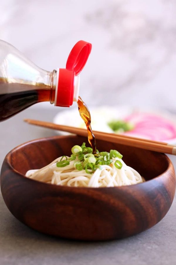 pouring sauce over cold somen noodles