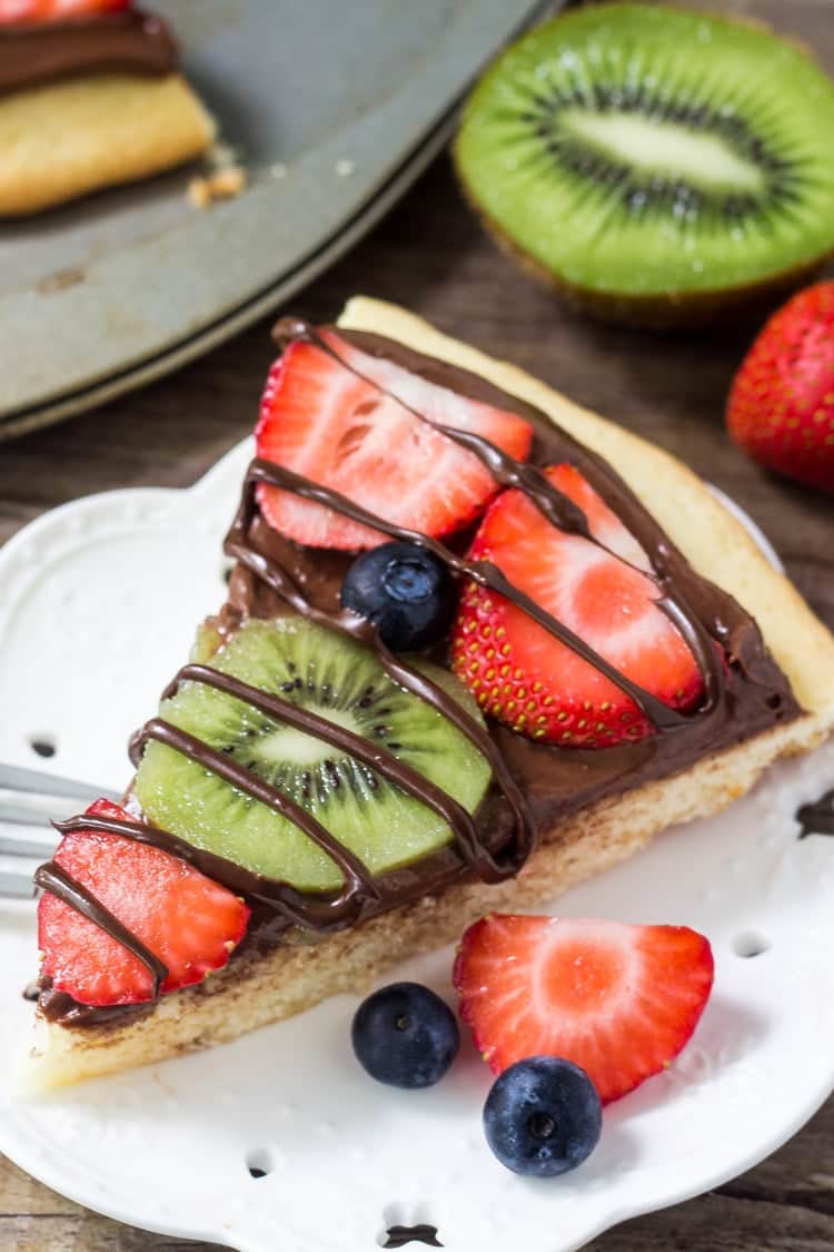 Chocolate fruit pizza is always a total crowd pleaser. With chewy sugar cookie, creamy chocolate cream cheese topping & fresh berries - you can't go wrong!