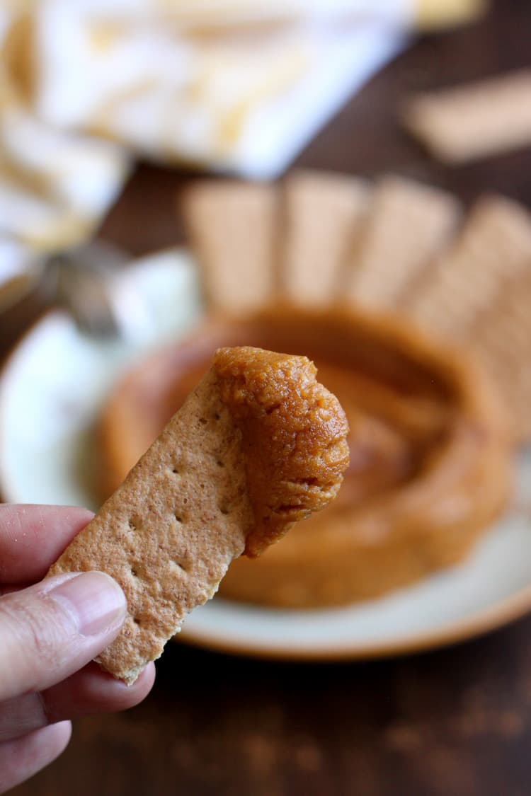 dipping graham crackers in pumpkin hummus