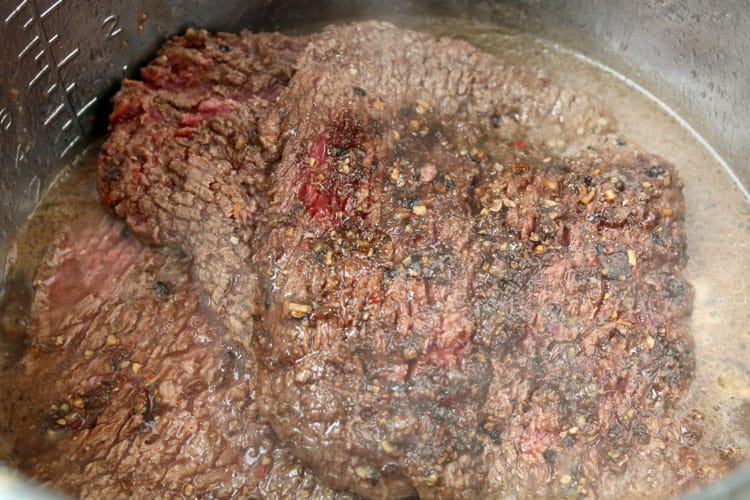 overhead view of cube steak recipes being made with several cube steaks almost cooked through