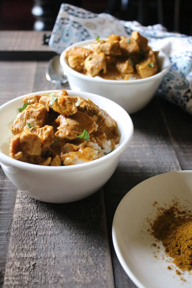 hot chicken curry in two white bowls