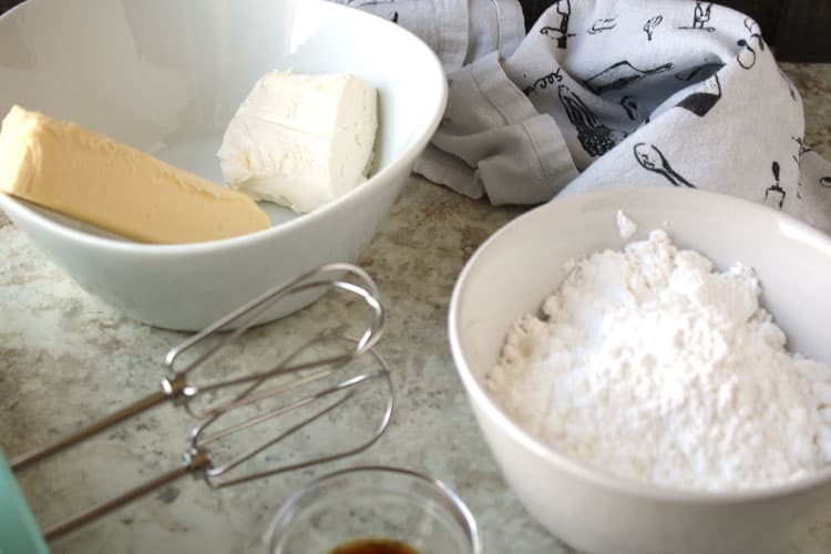 easy cream cheese frosting ingredients on a kitchen counter in white bowls