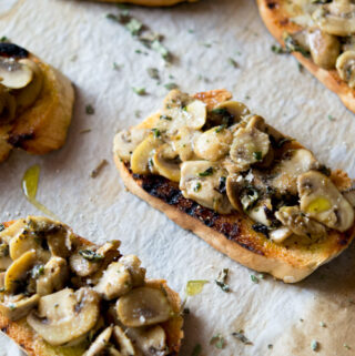 Parmesan mushroom crostini recipe. An easy Italian appetizer that's incredibly delicious and simple. Perfect for entertaining or a quick snack. Simple appetizers and easy snack recipes at all she cooks. Mushrooms, parmesan, oregano and garlic.