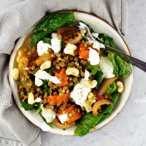 Overhead shot of squash salad with feta cheese, lentils and spinach
