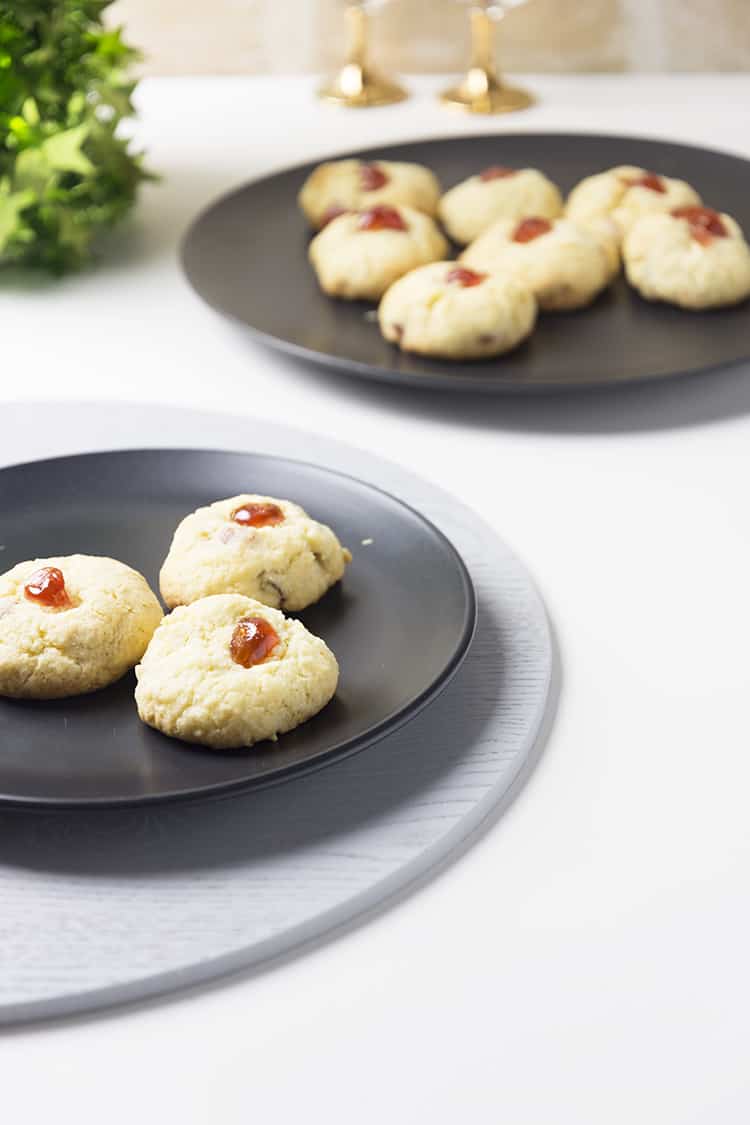 cherry almond cookies on a black plate