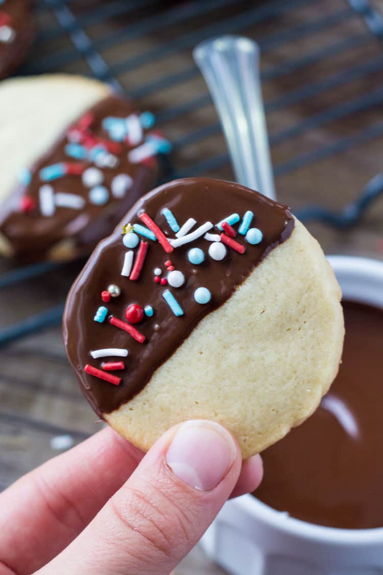 These easy chocolate dipped icebox cookies are the perfect make-ahead recipe for the holidays. Soft, buttery, dipped in chocolate & decorated with sprinkles.