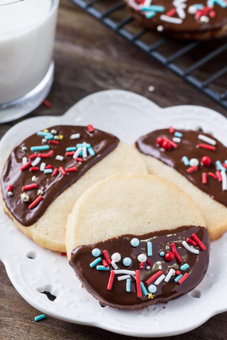 These easy chocolate dipped icebox cookies are the perfect make-ahead recipe for the holidays. Soft, buttery, dipped in chocolate & decorated with sprinkles.